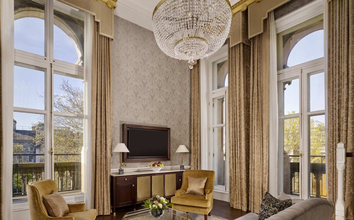 Living room with TV, couches and large windows with view in The College Green Hotel Dublin